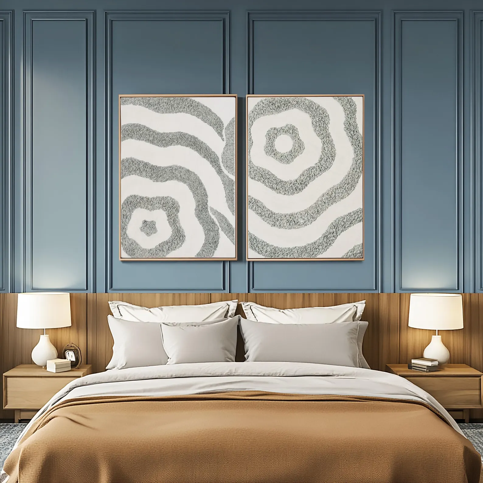 Two textured abstract canvas artworks displayed above a bed in a calm blue and neutral bedroom