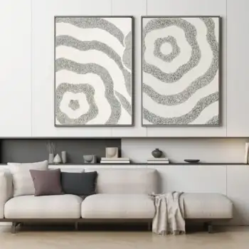 Set of two textured abstract canvas artworks styled above a neutral sofa in a modern living room