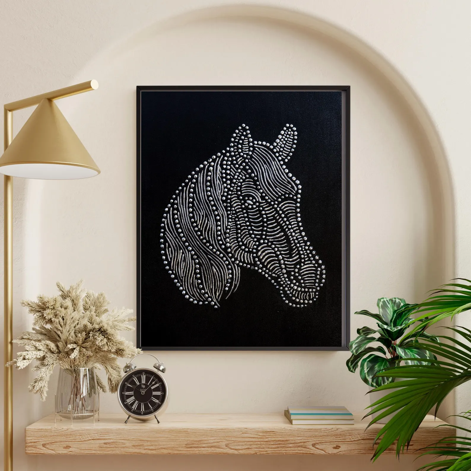 Textured horse wall art on black canvas styled with neutral decor, gold lamp and greenery