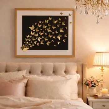 Gold butterfly scattering wall art styled above a bed in a warm bedroom setting with soft lighting and elegant decor.